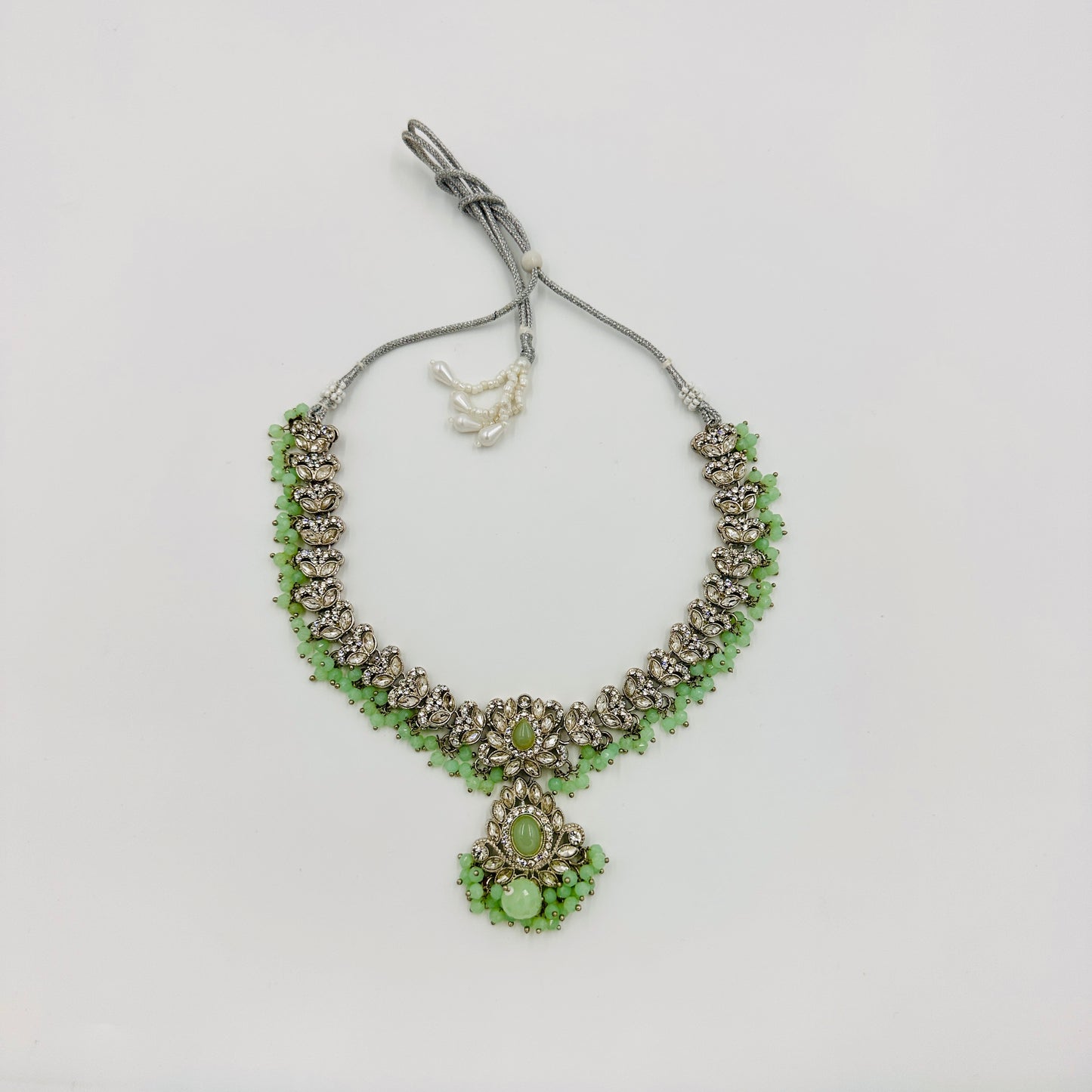 Silver-Plated Green Stone Kundan Choker Necklace Set with Jhumka Earrings & Maang Tikka