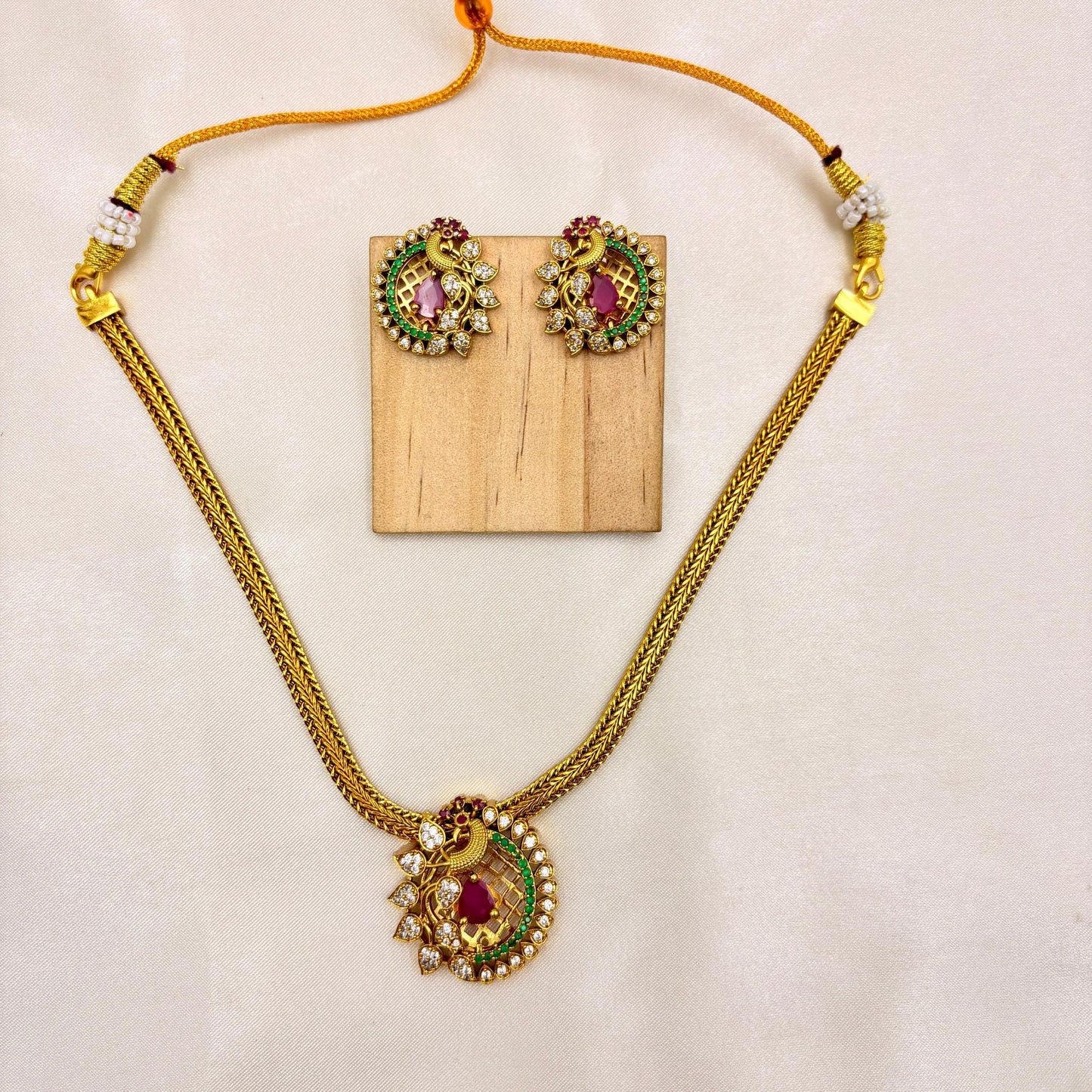 Traditional Peacock Pendant Necklace Set with Ruby & Green Stones – Gold Finish