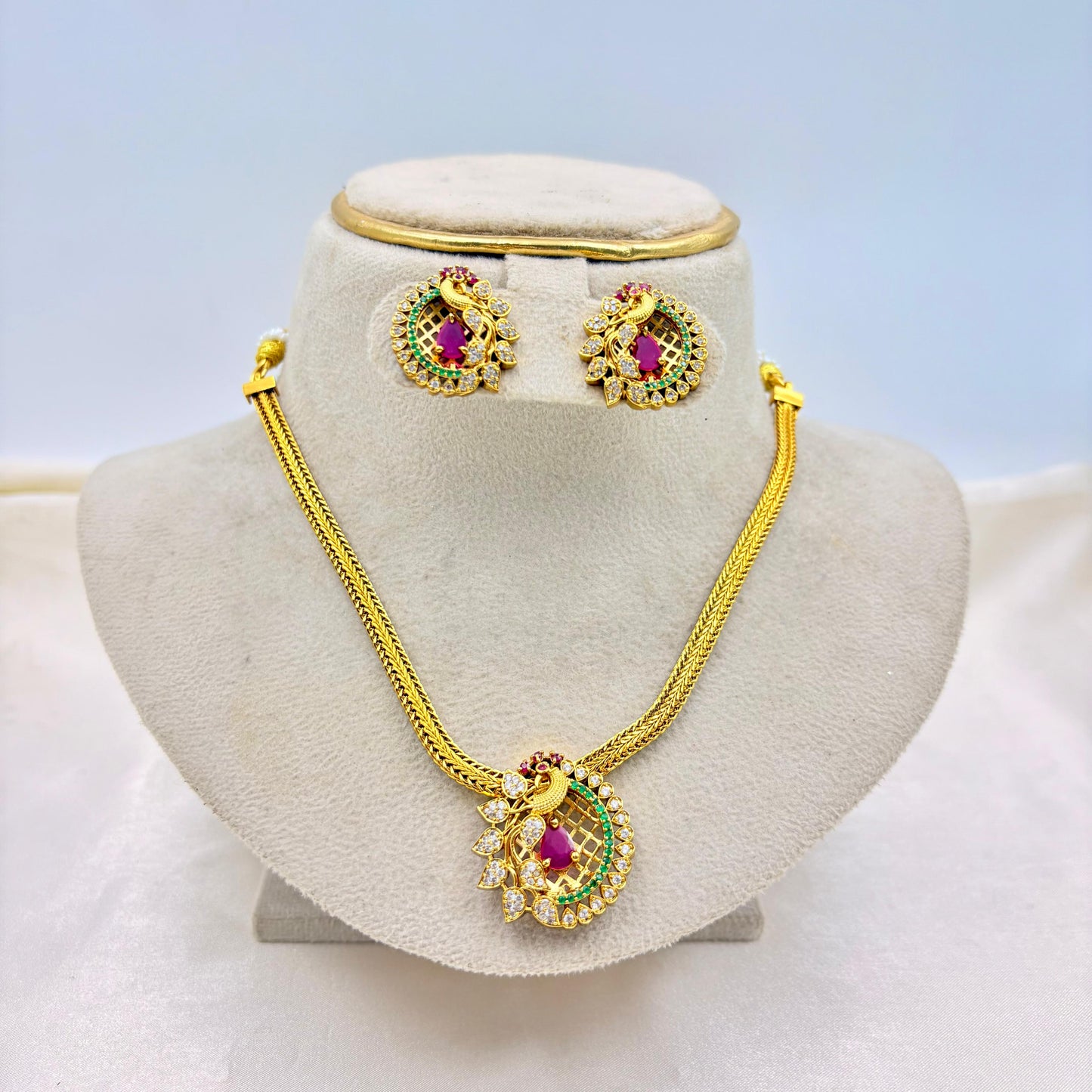 Traditional Peacock Pendant Necklace Set with Ruby & Green Stones – Gold Finish