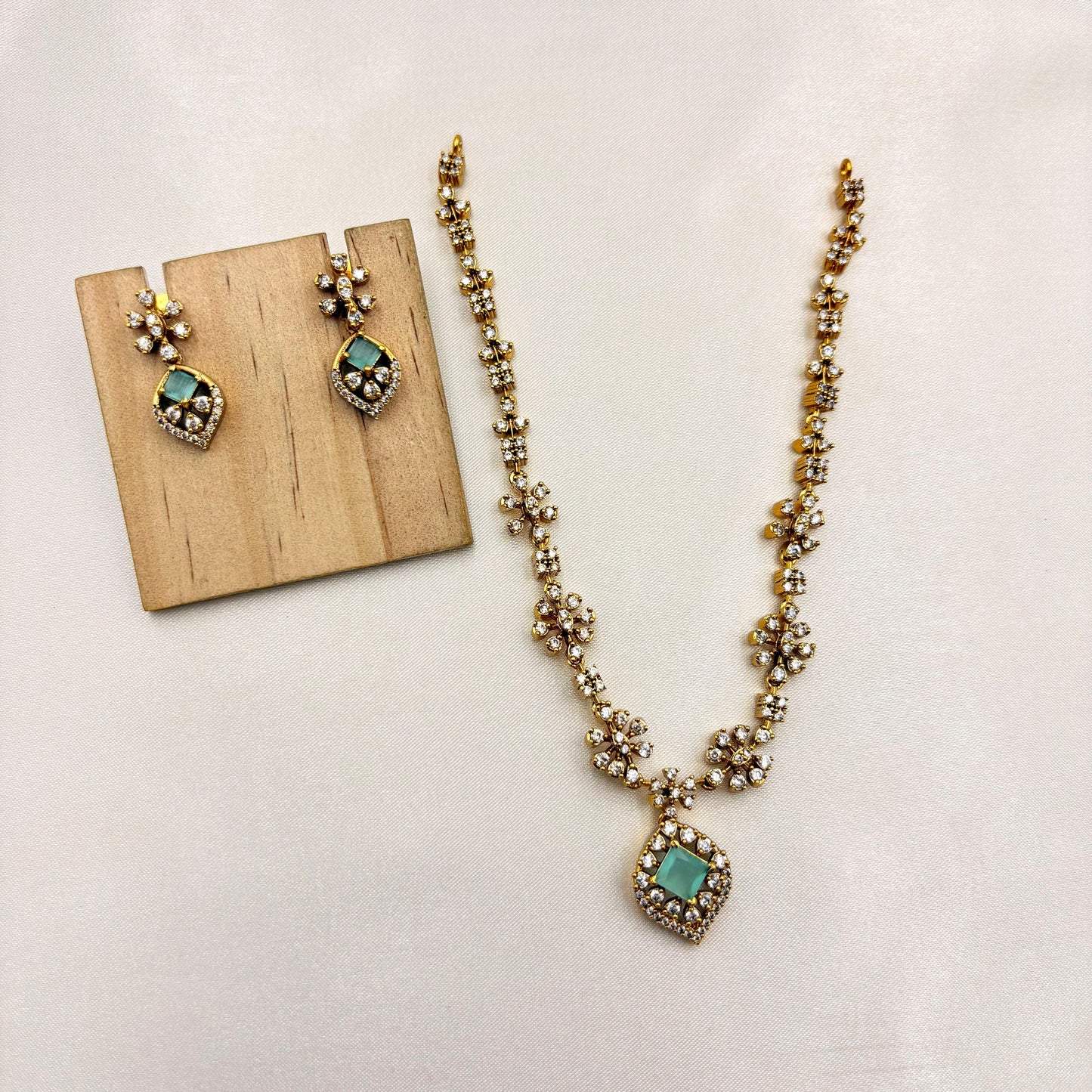 Elegant Floral CZ Necklace Set with Green Stone Pendant – Gold Finish