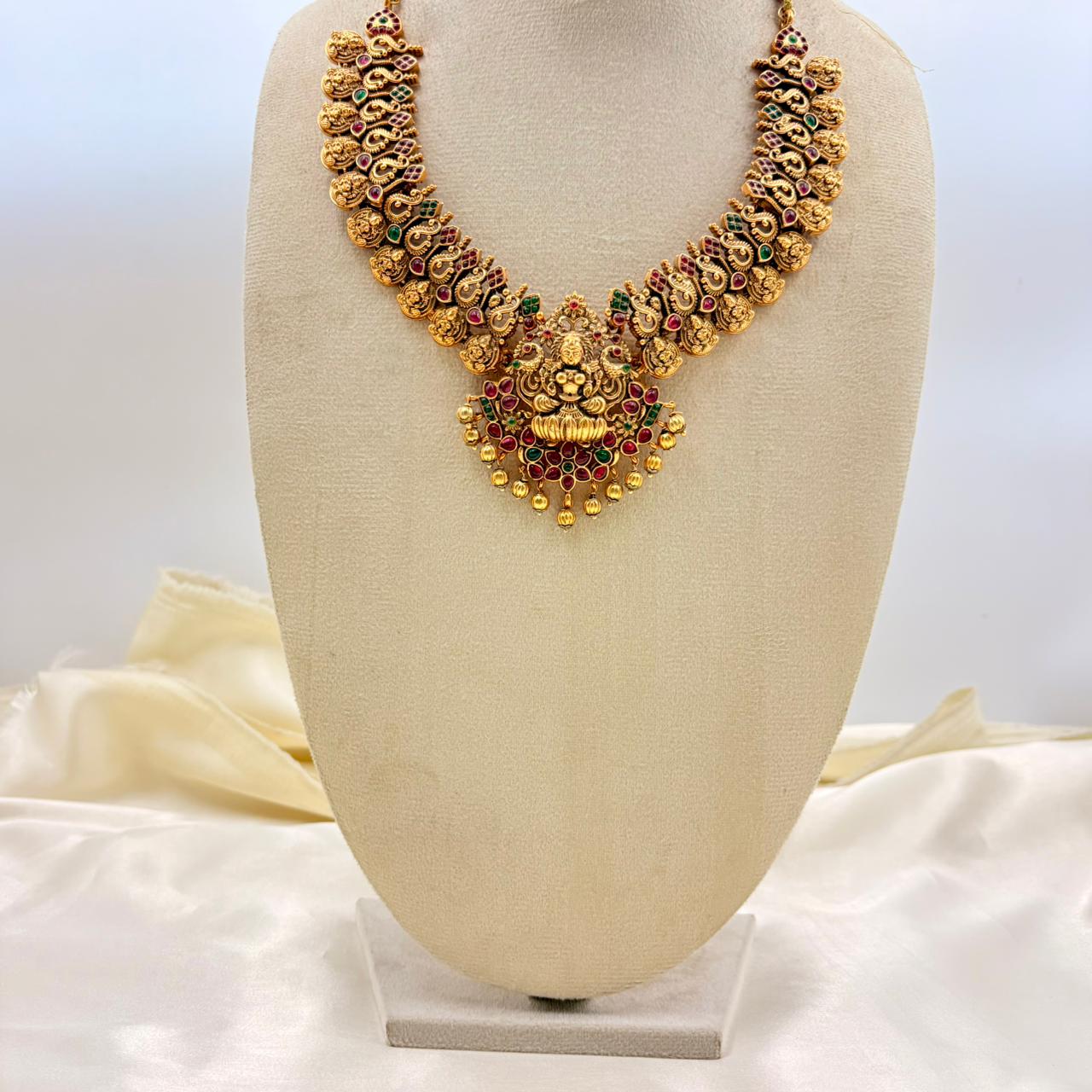 Traditional Lakshmi Temple Necklace with Ruby & Green Stones – Gold Finish
